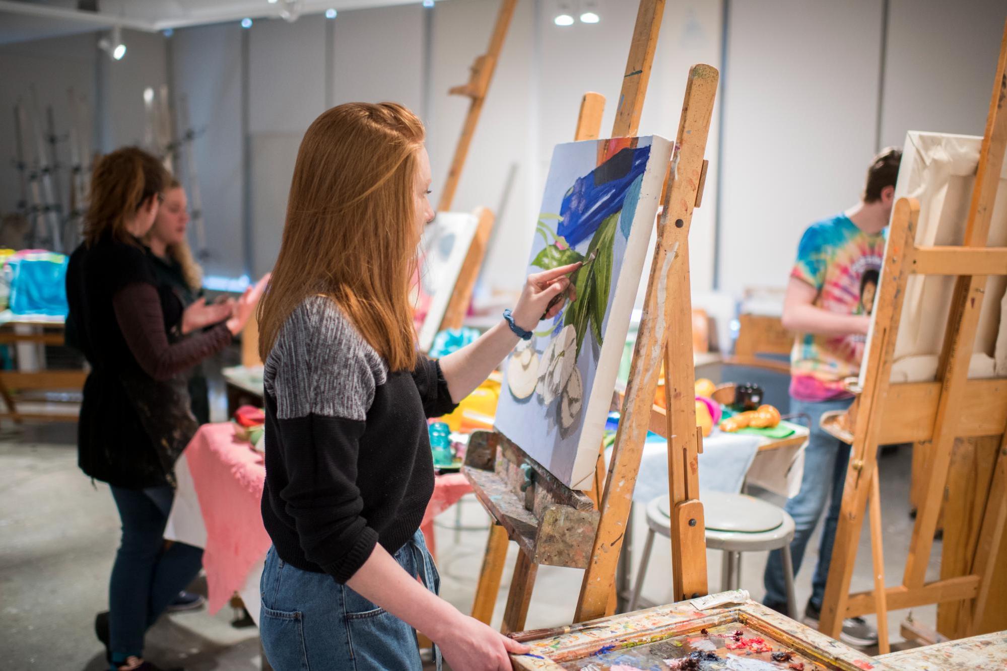 Students painting on easels